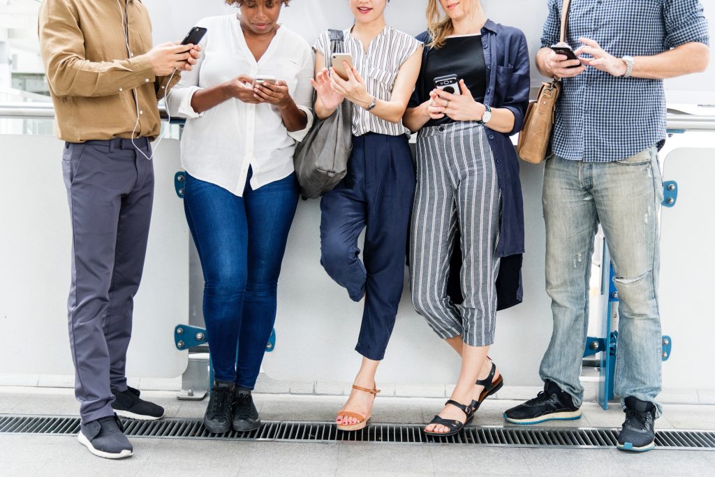 People standing and staring at smartphone