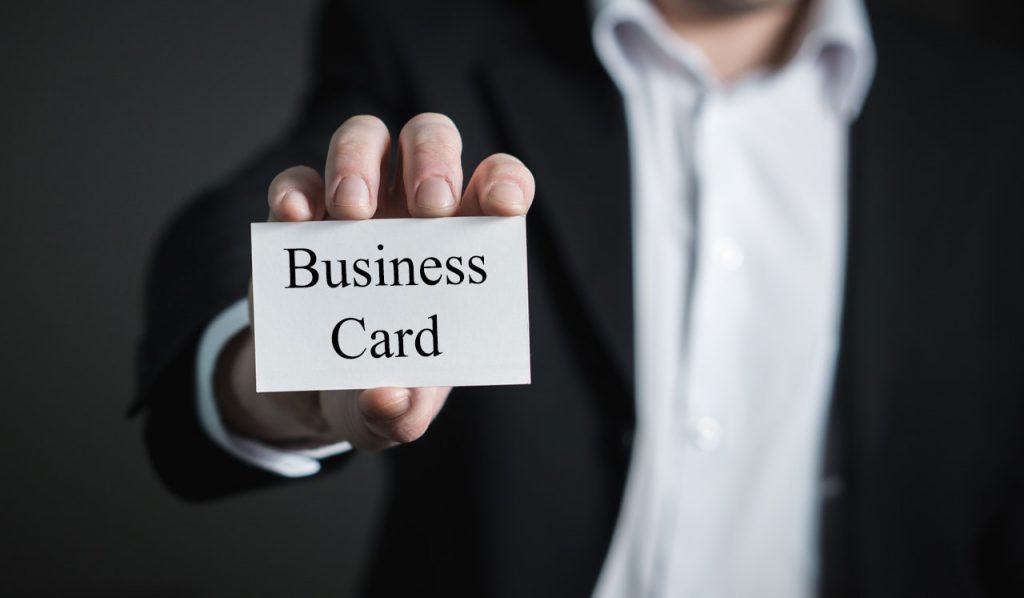 Business man holding a business card