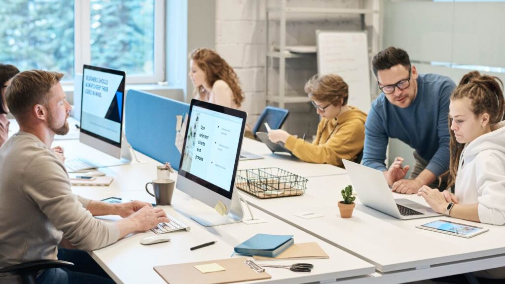 Group of employees working on computers in a modern workplace 